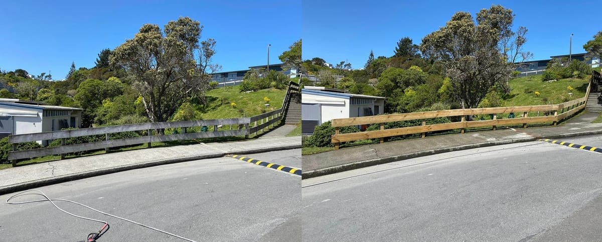 Wellington school driveway cleaning at Newlands College, sealed driveway and new timber post and rail handrails softwashed, lifting weathering from the boards along the campus boundary.